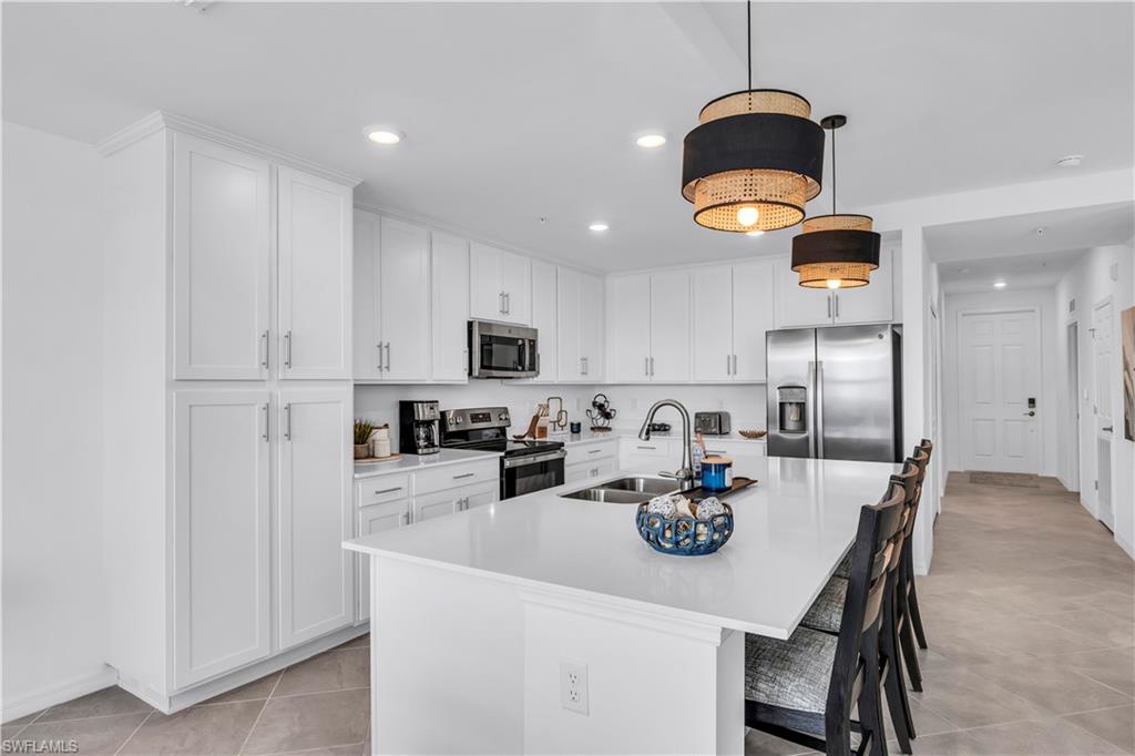 43989 Boardwalk Loop, Unit 2032 Punta Gorda, FL 33982 - Photo 4 of 14 a kitchen with stainless steel appliances granite countertop a sink a stove and refrigerator