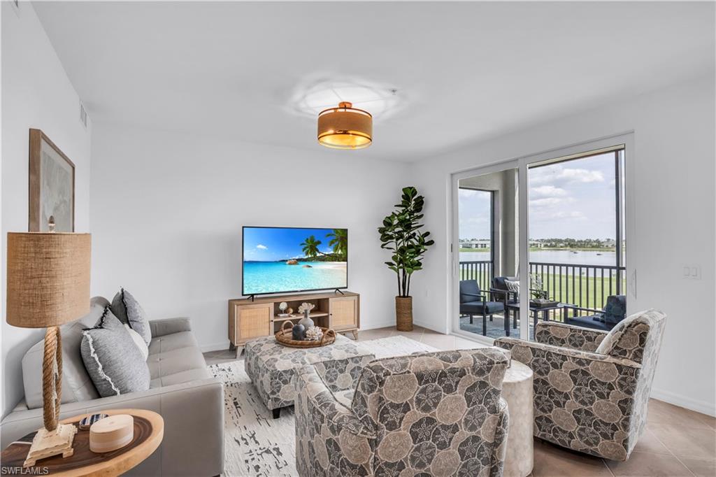 43989 Boardwalk Loop, Unit 2032 Punta Gorda, FL 33982 - Photo 6 of 14 a living room with furniture and a potted plant