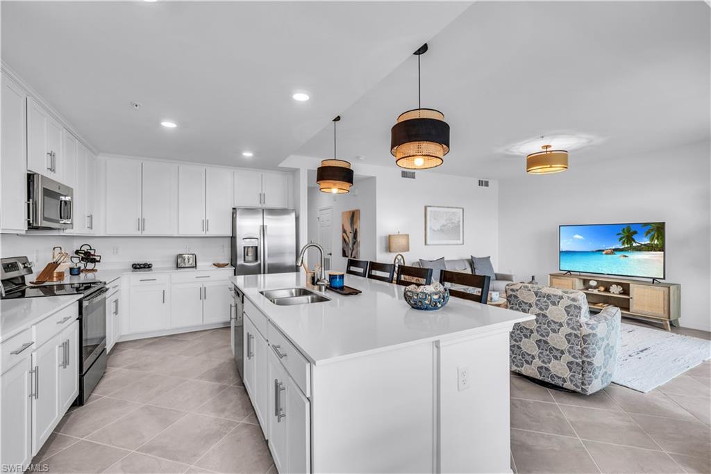 43989 Boardwalk Loop, Unit 2032 Punta Gorda, FL 33982 - Photo 8 of 14 a kitchen with stove and cabinets