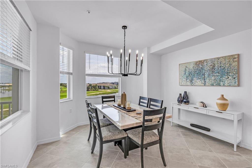 43989 Boardwalk Loop, Unit 2032 Punta Gorda, FL 33982 - Photo 9 of 14 a dining room with furniture a chandelier and window