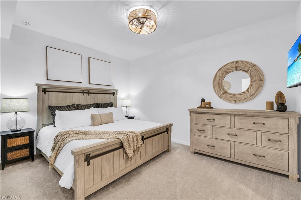 43989 Boardwalk Loop, Unit 2032 Punta Gorda, FL 33982 - Photo 10 of 14 a bedroom with a bed and a table