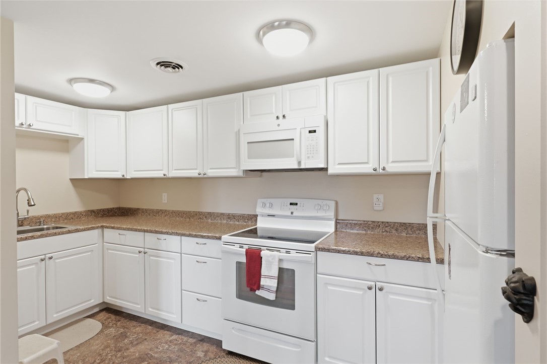 4536 Crystal Ridge Circle Gorham, NY 14424 - Photo 32 of 48 This modern lower-level kitchen is designed for maximum convenience, featuring high-end finishes and functional workspace that is perfect for hosting guests. This space provides the extra cooking capacity you need for seamless entertaining, with easy access to the outdoor patio area for effortless indoor-outdoor dining and social gatherings.