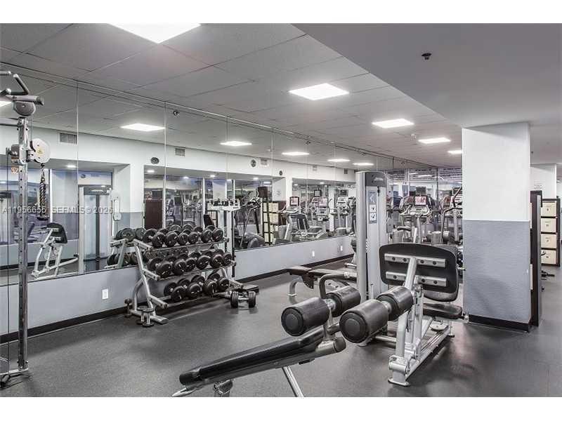 100 Lincoln Road, Unit 1112 Miami Beach, FL 33139 - Photo 30 of 48 a room with gym equipment and lots of wooden floors