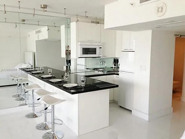 a kitchen with stainless steel appliances granite countertop a sink and cabinets