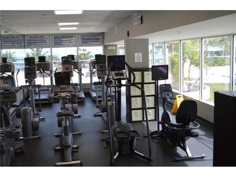 100 Lincoln Road, Unit 1112 Miami Beach, FL 33139 - Photo 31 of 48 a room with lots of chairs and mirrors