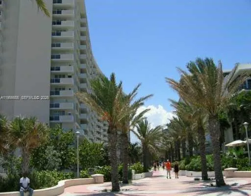 a view of a yard with plants and trees