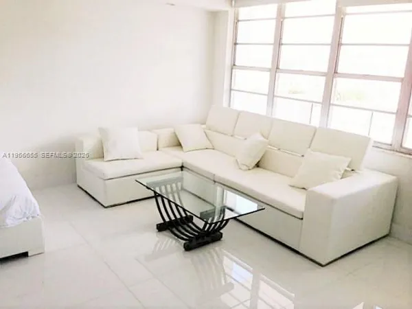 a living room with furniture and a window