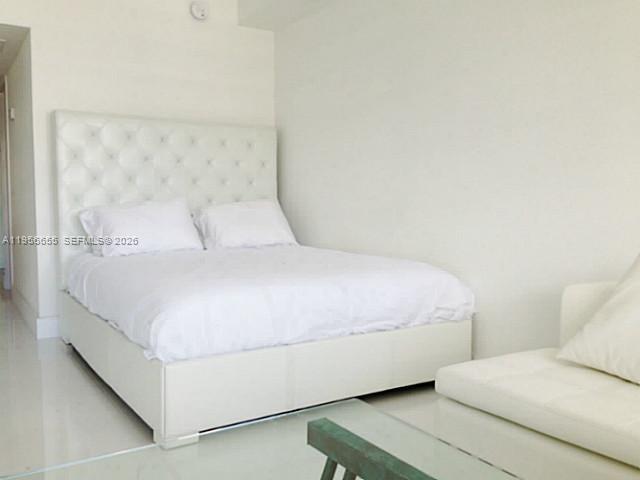 100 Lincoln Road, Unit 1112 Miami Beach, FL 33139 - Photo 9 of 48 a bedroom with a bed and a white wall