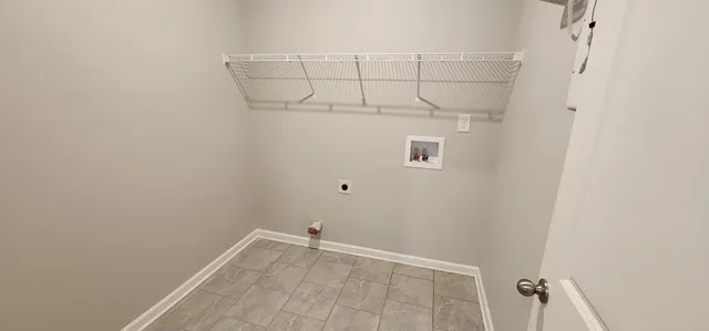a view of an empty room with closet and mirror