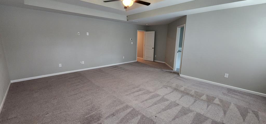 486 Abberly Lane Ellerslie, GA 31807 - Photo 36 of 67 an empty room with a ceiling fan and carpet