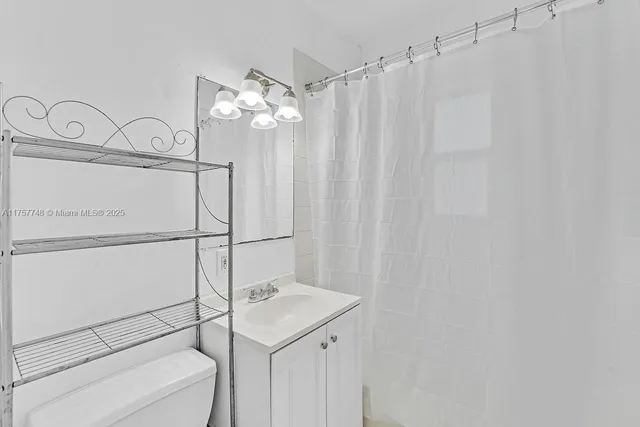 a bathroom with a shower curtain and a sink