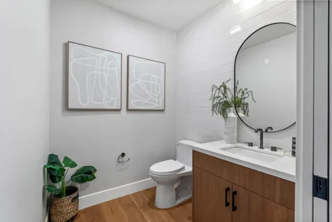 a bathroom with a granite countertop sink a toilet and bathtub