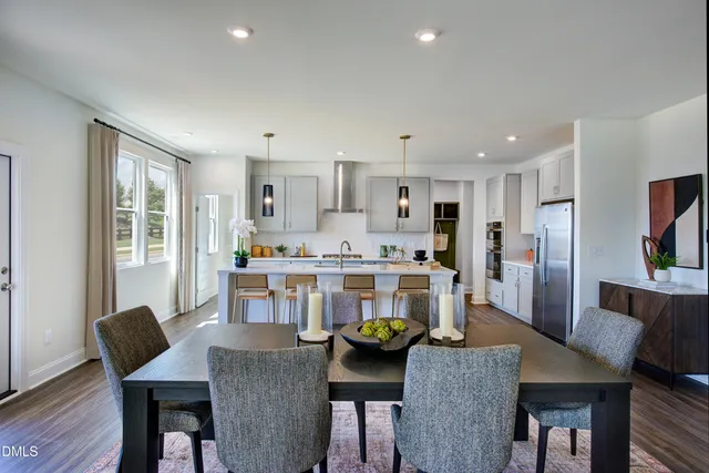 a living room with stainless steel appliances kitchen island granite countertop furniture and a kitchen view