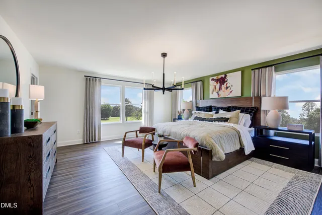 a bedroom with bed and wooden floor