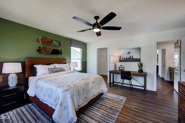 a bedroom with bed and wooden floor