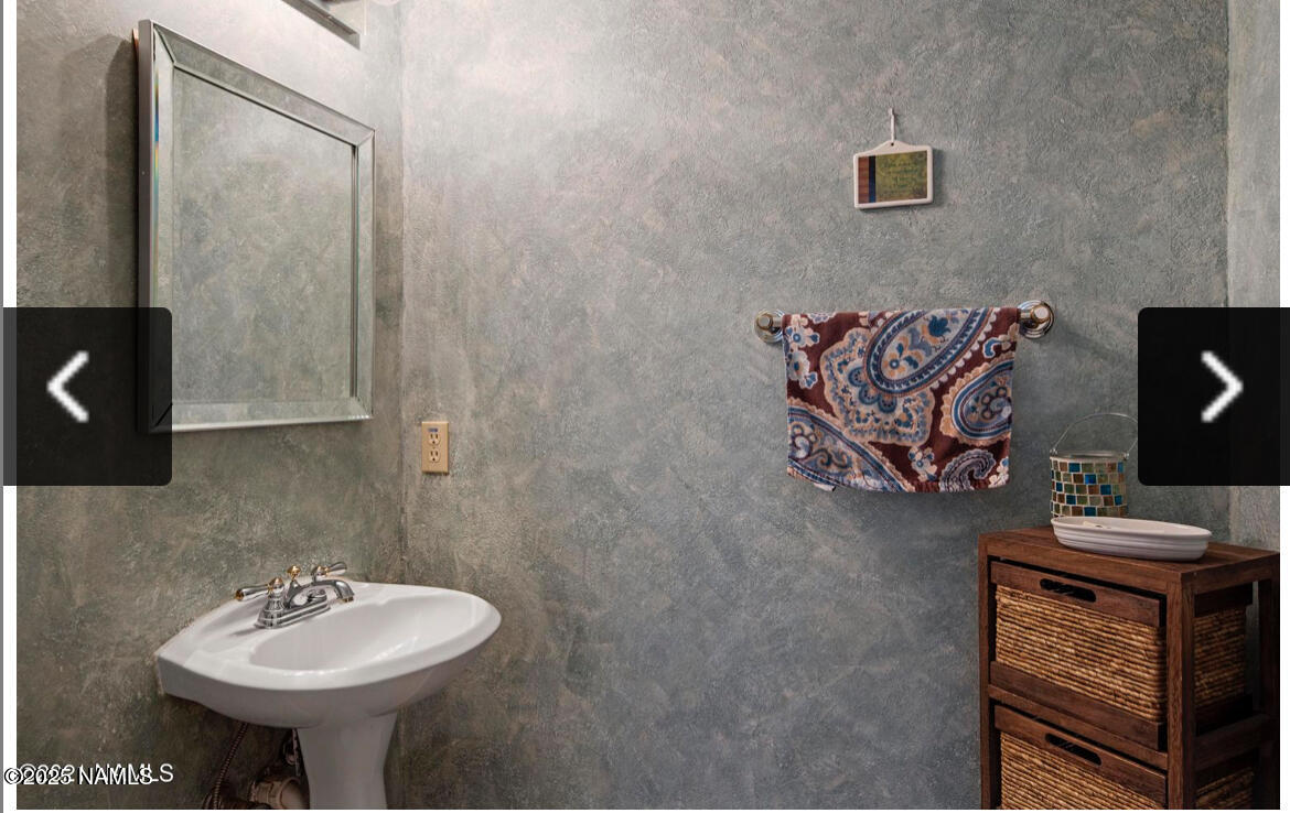4011 East Village Circle Flagstaff, AZ 86004 - Photo 14 of 23 a bathroom with a sink and a mirror