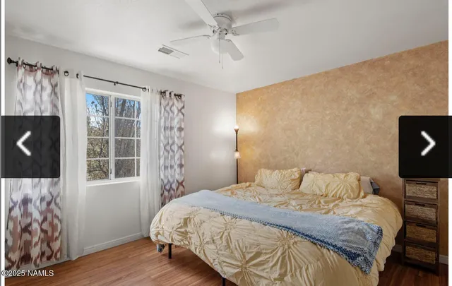 a bedroom with a bed and a lamp on dresser