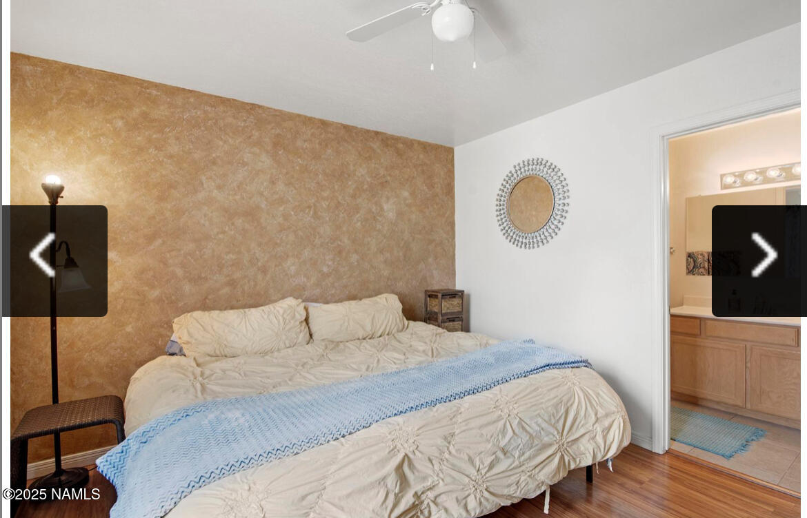 4011 East Village Circle Flagstaff, AZ 86004 - Photo 16 of 23 a bedroom with a bed and a lamp on dresser