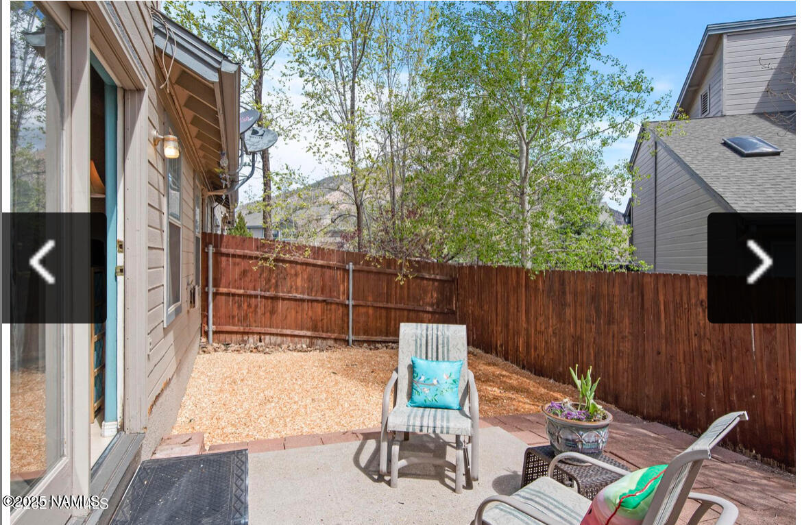 4011 East Village Circle Flagstaff, AZ 86004 - Photo 23 of 23 a view of a chairs and table in the back yard of the house