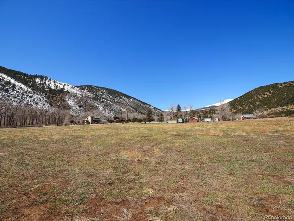 a view of a large building with mountains in the background
