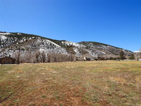a view of a field with an ocean