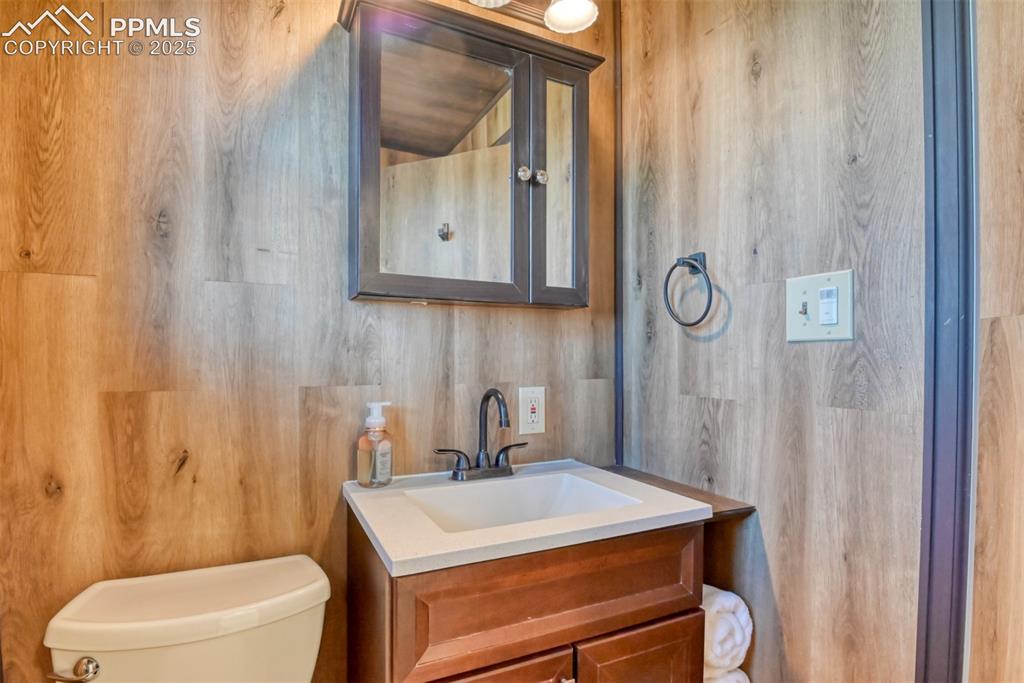10970 Garrett Road Peyton, CO 80831 - Photo 21 of 50 a bathroom with a sink a toilet and shower curtain