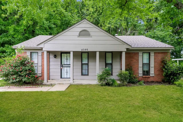 a front view of a house with a yard and porch
