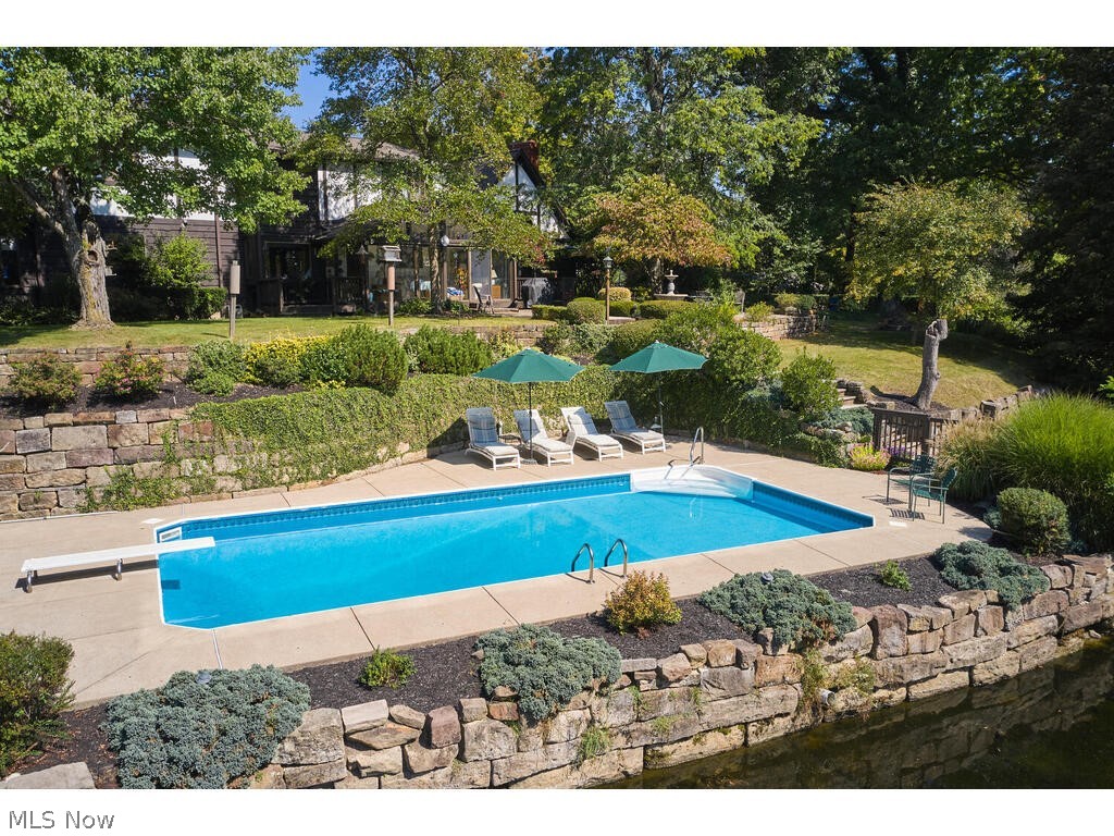 3376 West Bath Road Akron, OH 44333 - Photo 39 of 49 View of pool with a diving board and a patio, plus the lake