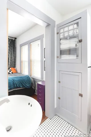 a bathroom with a tub and shower