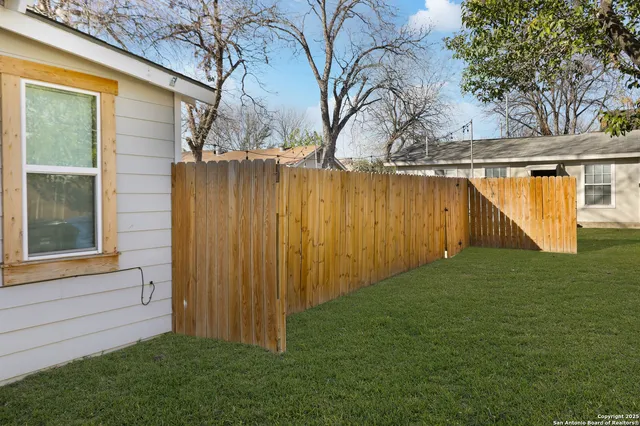a view of backyard with tub and trees