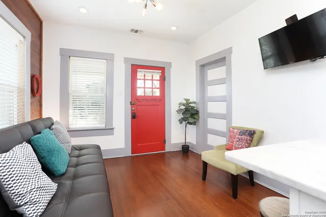 a living room with furniture and a flat screen tv