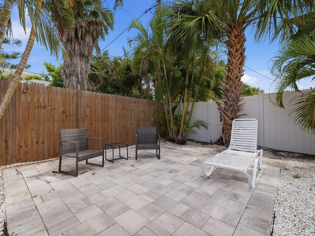 1207 1st Street Indian Rocks Beach, FL 33785 - Photo 34 of 60 a backyard of a house with seating space