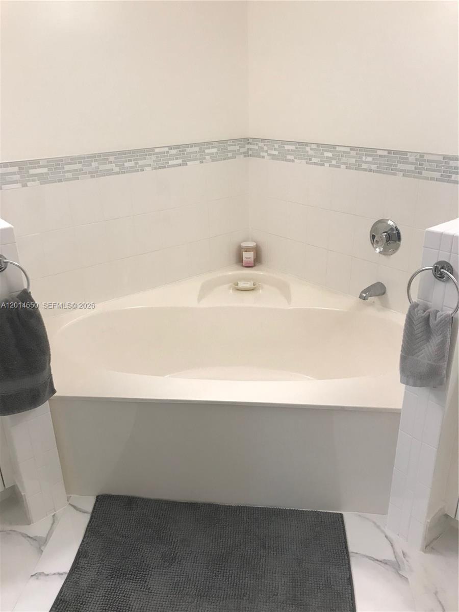 16654 Southwest 103rd Lane Miami, FL 33196 - Photo 16 of 20 a bathroom with a bathtub and shower