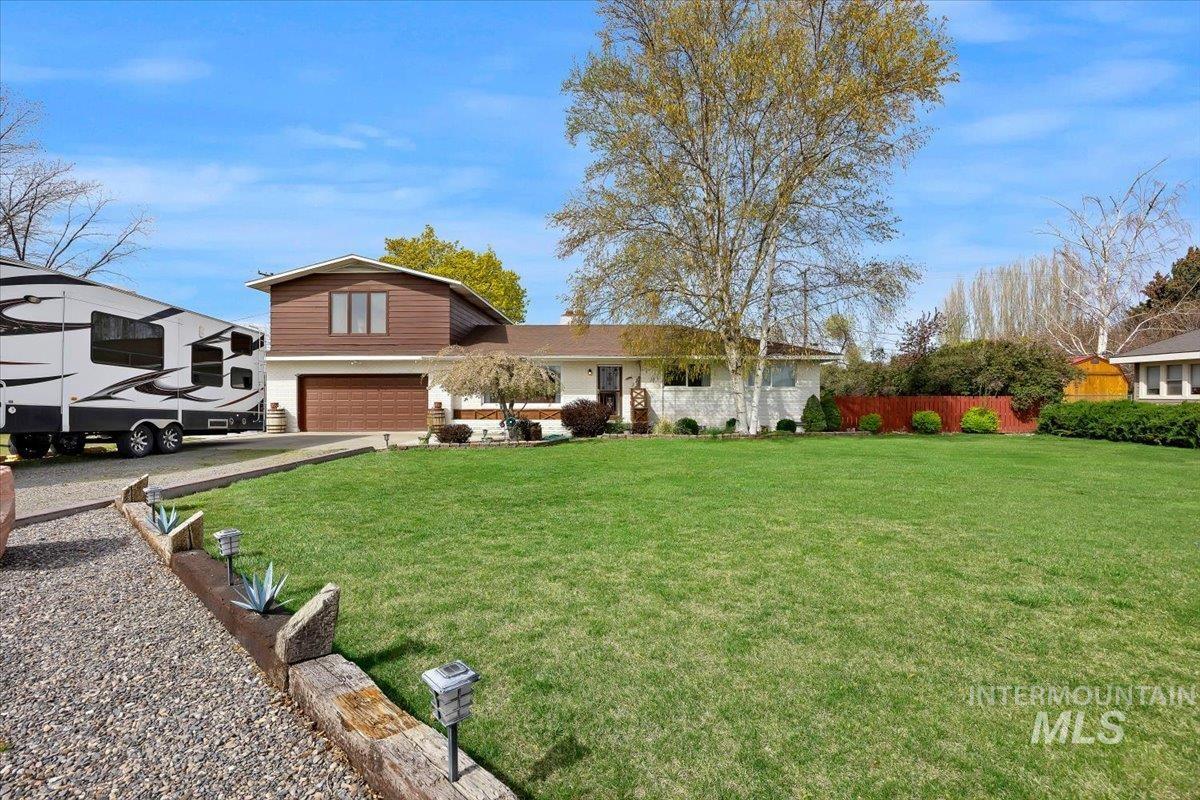 View of front of home featuring driveway and an attached garage