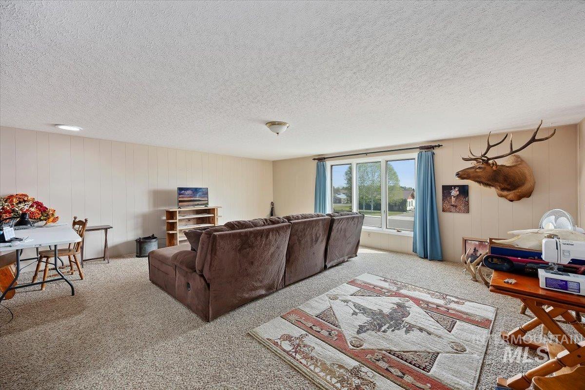 1301 A Street Rupert, ID 83350 - Photo 19 of 45 Living room featuring a textured ceiling and light colored carpet