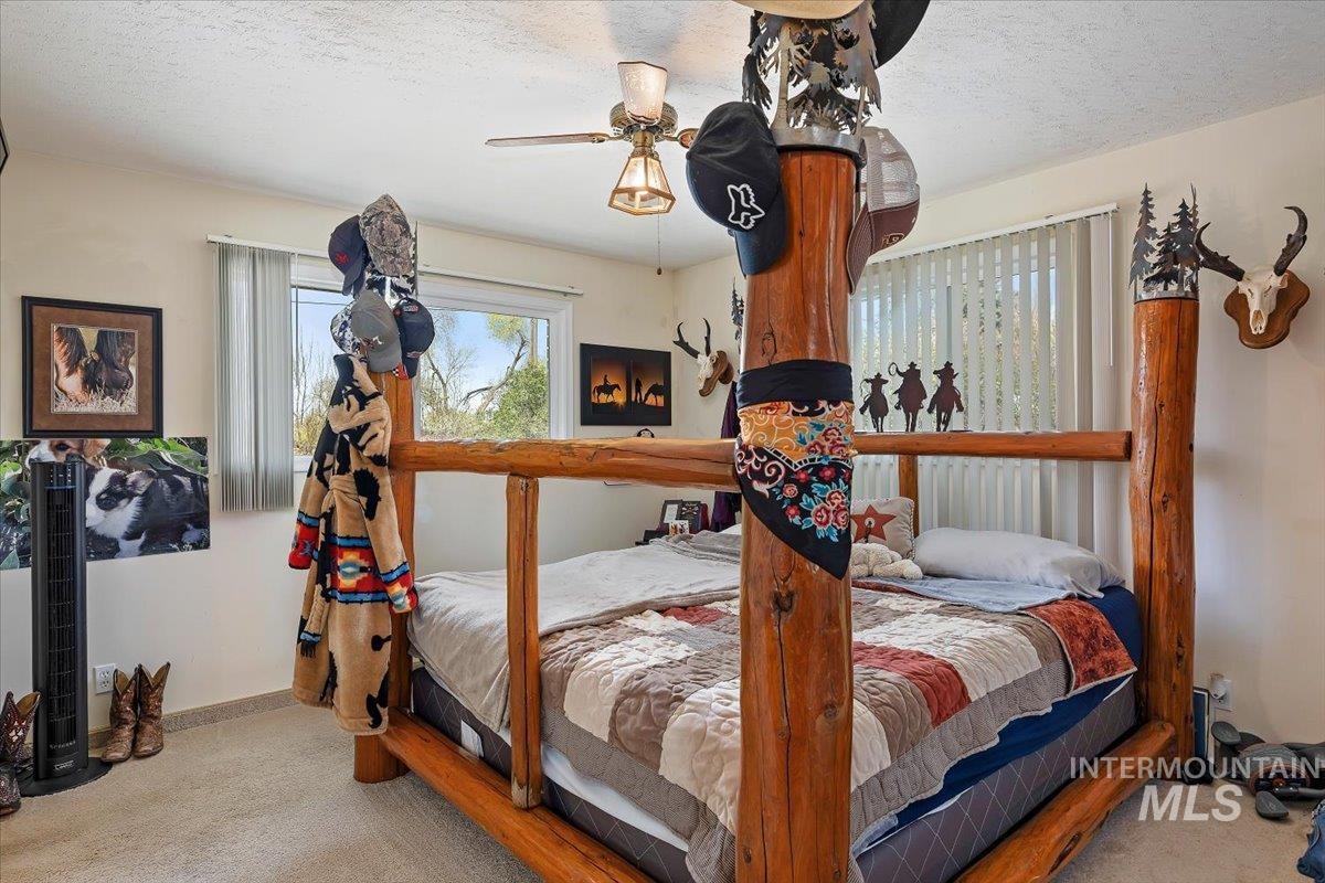1301 A Street Rupert, ID 83350 - Photo 22 of 45 Bedroom featuring light carpet, ceiling fan, and a textured ceiling
