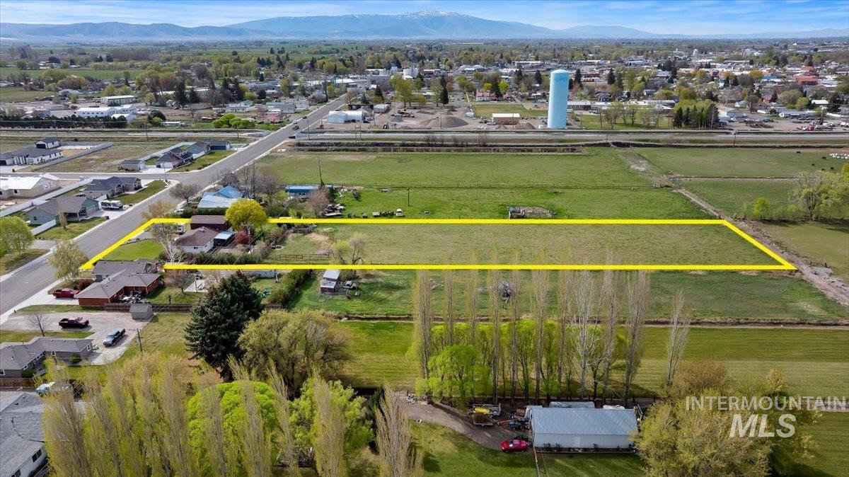 1301 A Street Rupert, ID 83350 - Photo 35 of 45 Aerial view of residential area featuring property parcel outlined and mountains