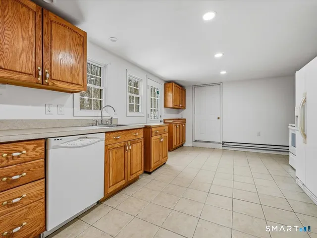 a view of kitchen with stainless steel appliances granite countertop a stove and a refrigerator