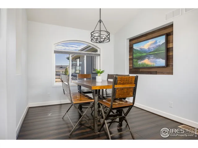 a living room with furniture and a ceiling fan