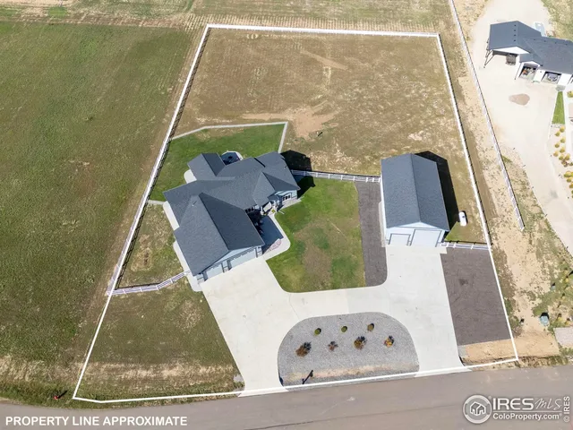 a front view of a house with a yard table and chairs