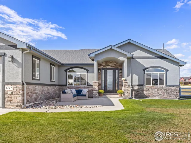 a front view of a house with outdoor seating