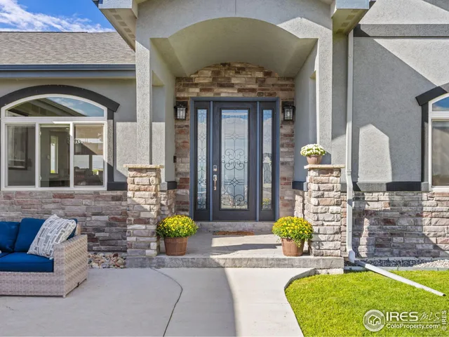 a kitchen with stainless steel appliances kitchen island granite countertop a table chairs and a refrigerator