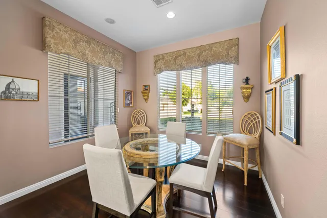 a view of a dining room with furniture wooden floor and a potted plant