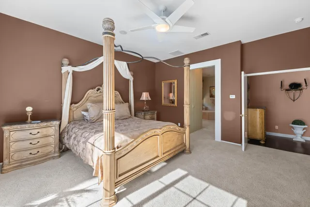 a bedroom with a bed and a chandelier