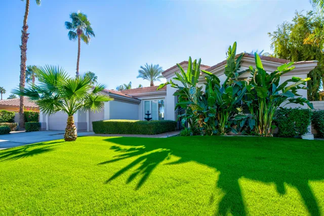 a view of a garden with a house