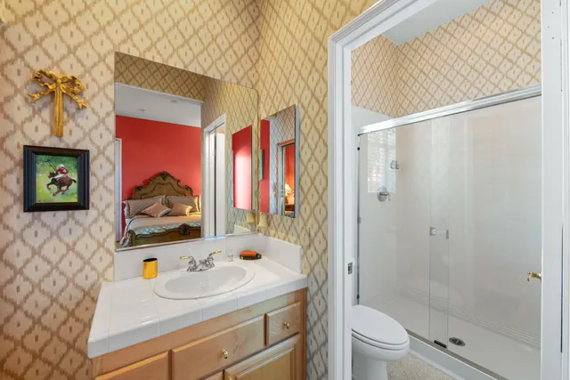 a bathroom with a sink toilet and shower