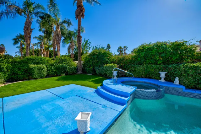 a view of yard with swimming pool and green space