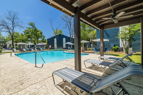 a view of a backyard with swimming pool