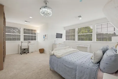 a bedroom with a bed furniture and windows