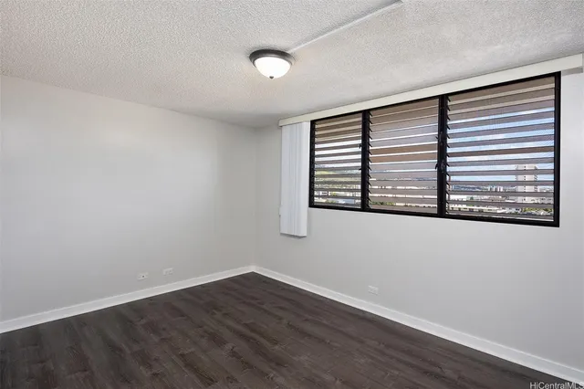 a view of a room with wooden floor and a window